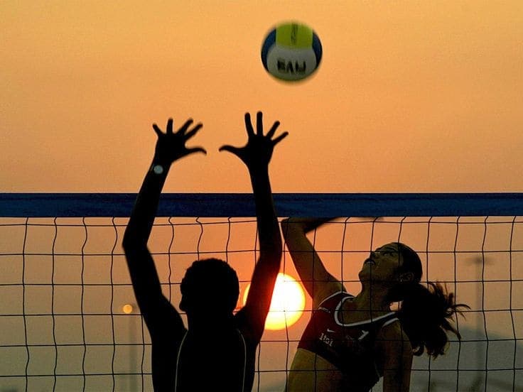 Beach volleyball at sunset on the Dinklr sand court