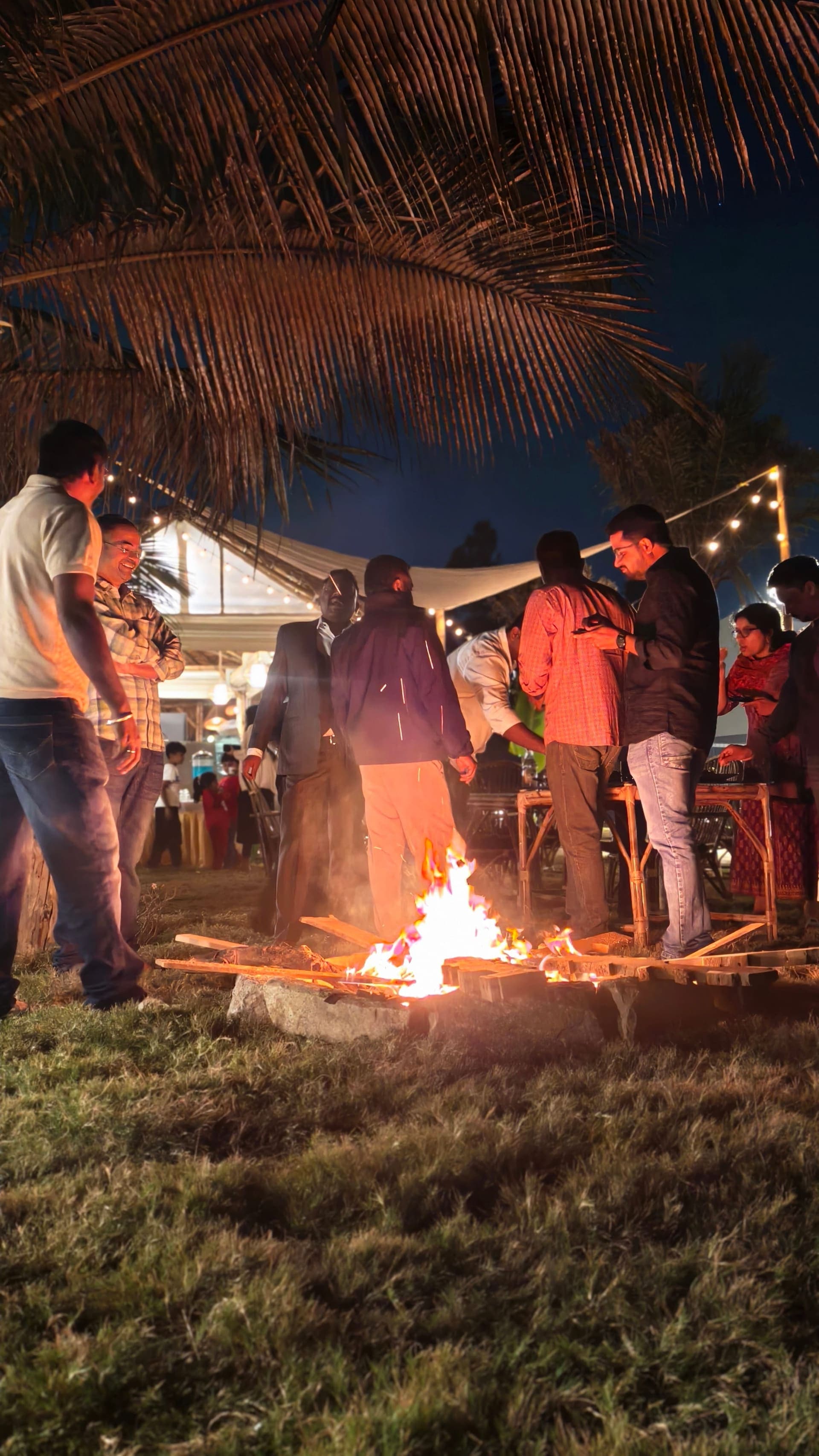 A team gathered round the bonfire at Dinklr after dark