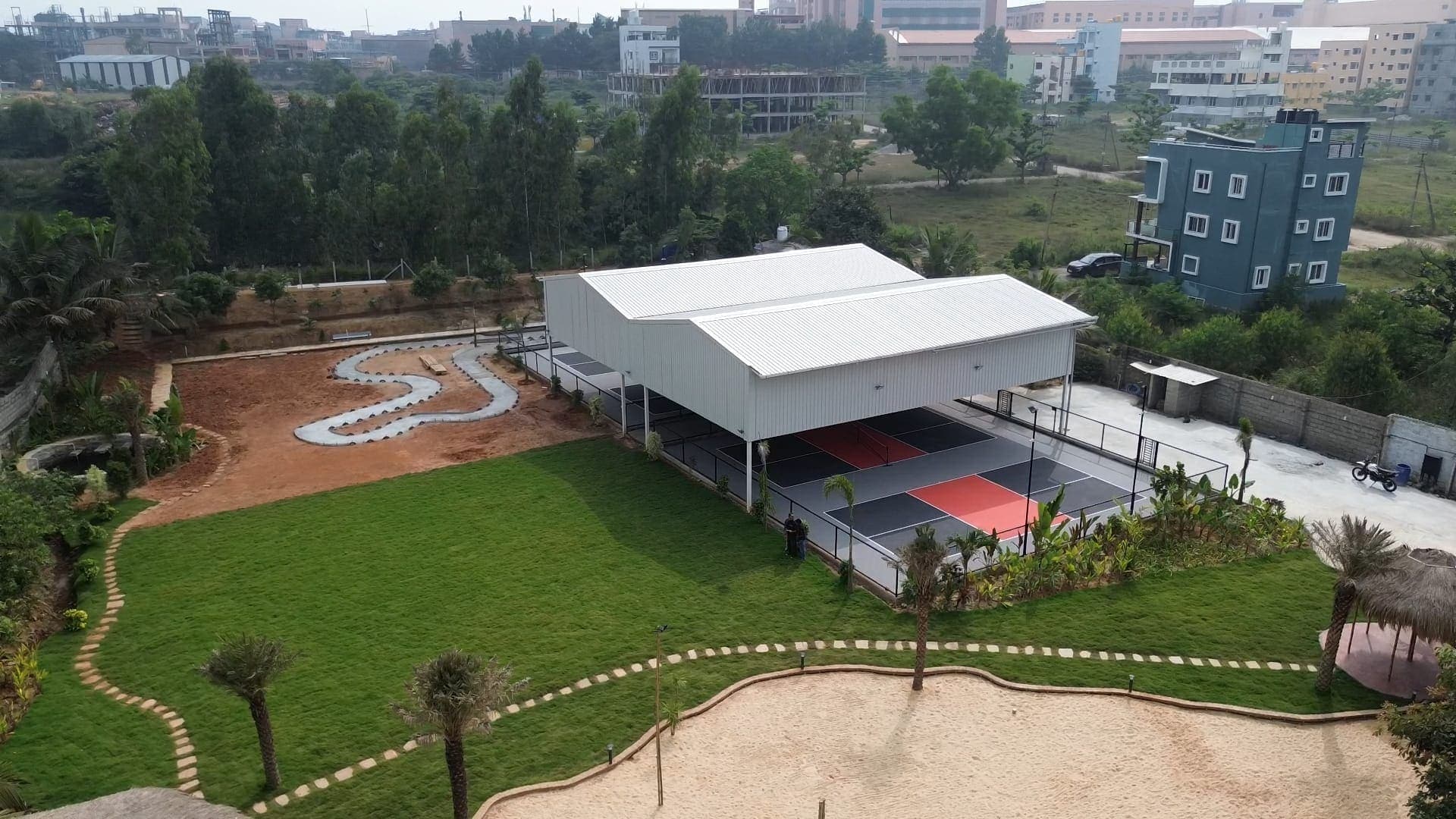 Aerial view of Dinklr: courts, sand court and gardens by the lake