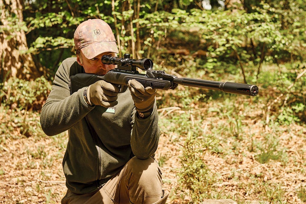 Guest aiming an air-rifle on the Dinklr range